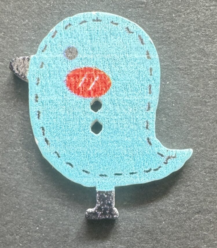 Botón pollito azul con punteado